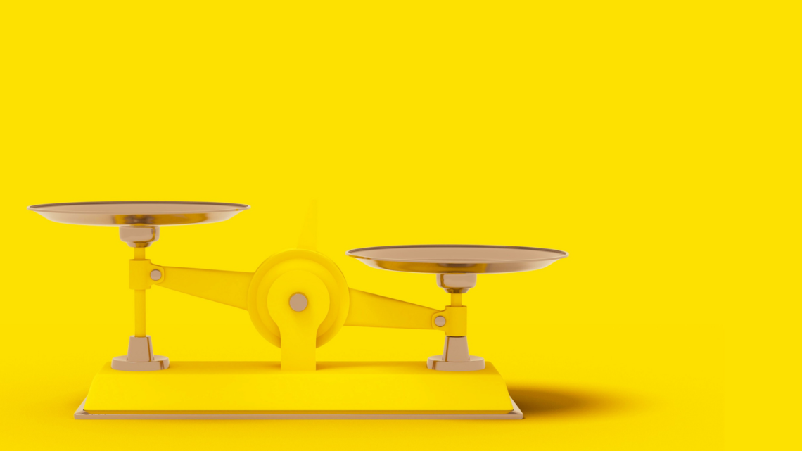 Weighted scales on yellow background