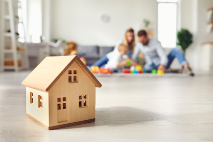 an image of a house with a family in the background