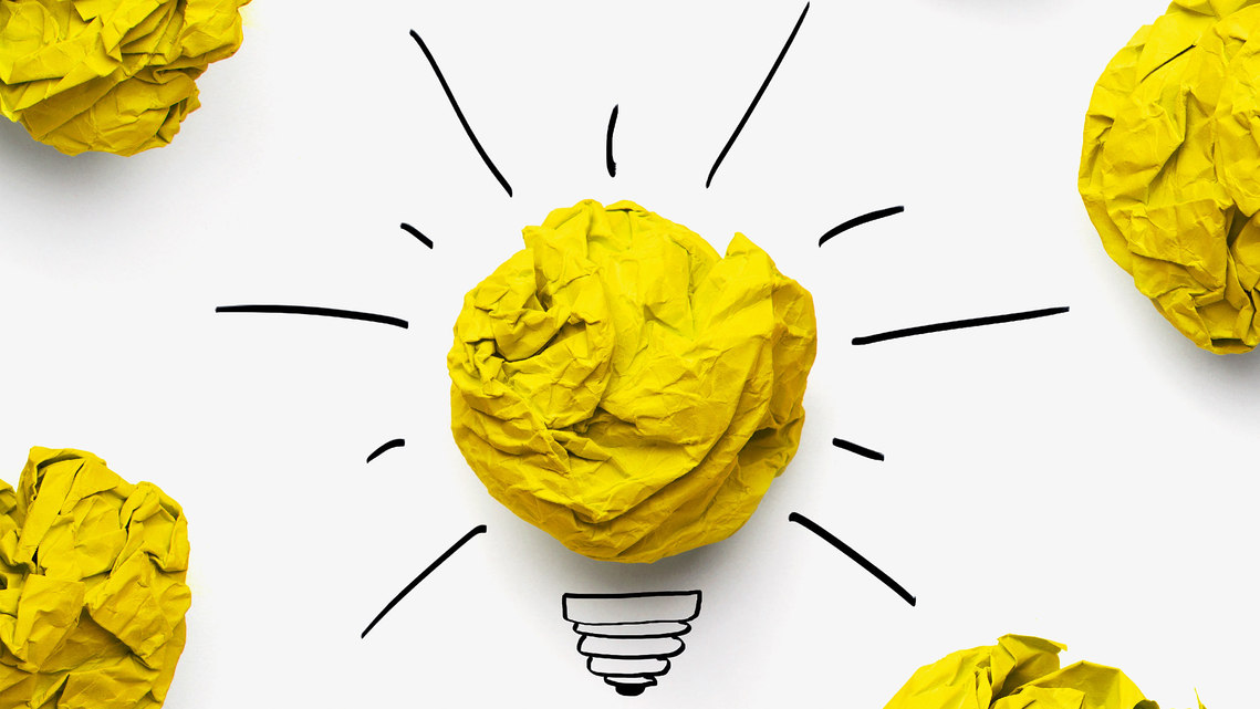 Photo of crumpled yellow paper as a shining lightbulb